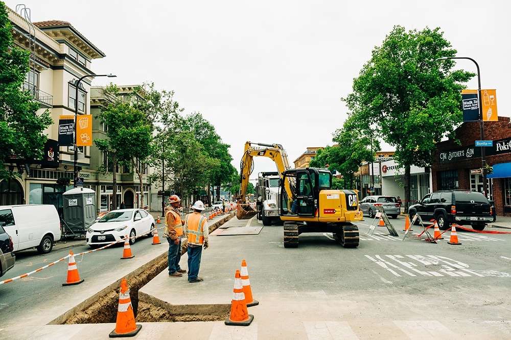 Excavator digging a trench for pipeline construction